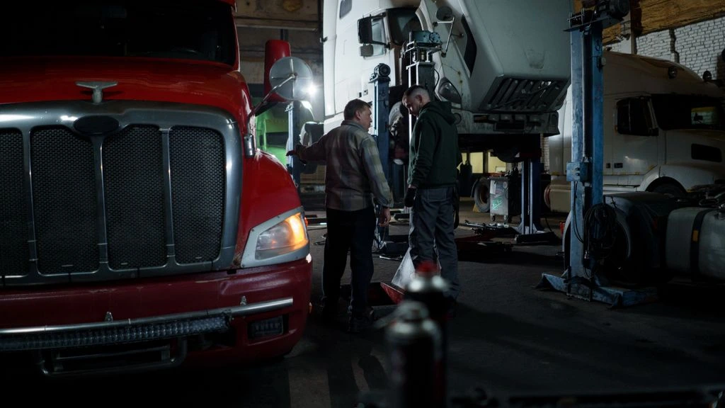 FleetPro technician servicing a work truck in a Tire Town Team service bay